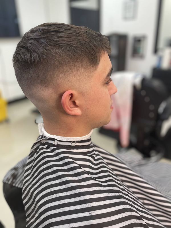 A short back and sides with a soft-edged fade and neat neckline.
