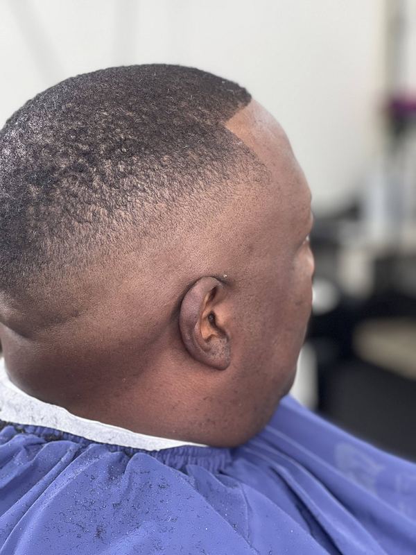 A close, high fade shaped around the ear with a crisp line-up.