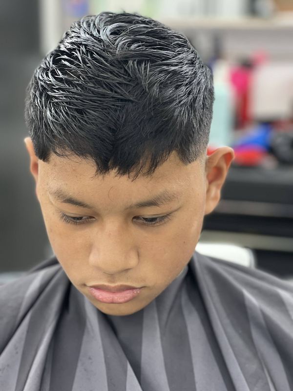 A young client with a textured crop cut, viewed from above.