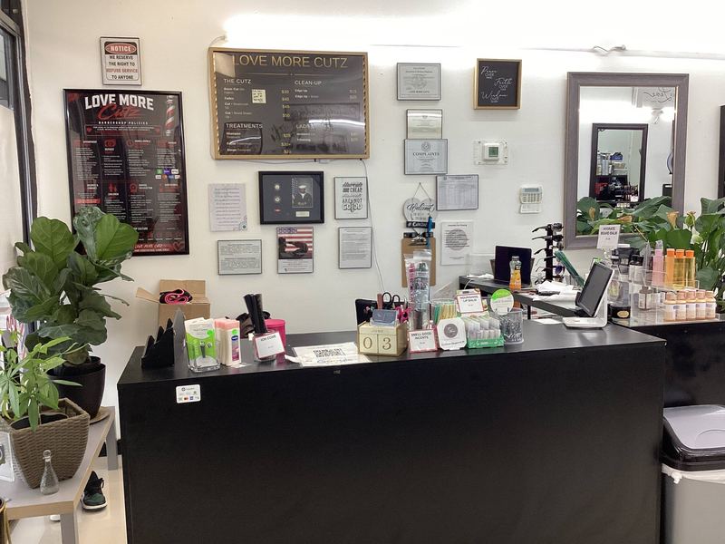 The front desk, stocked with products and framed certificates on the wall behind.