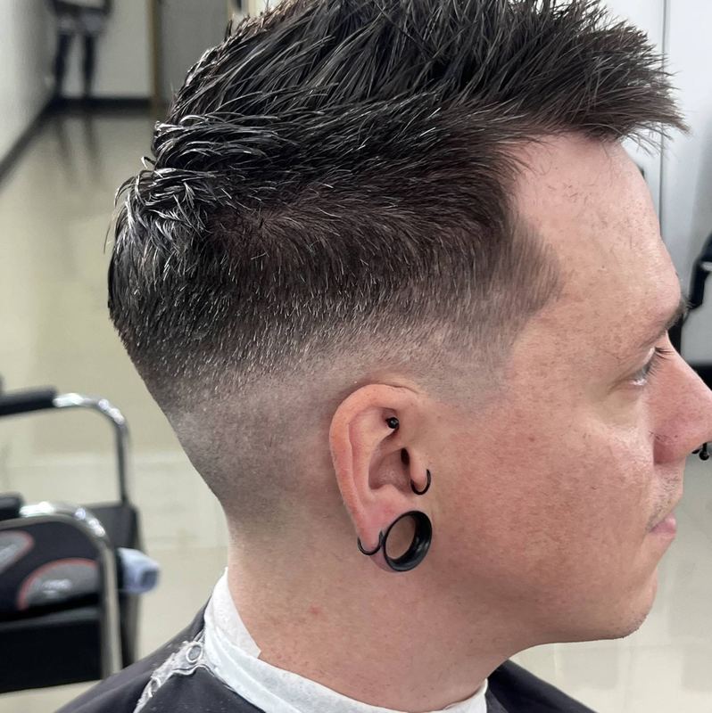 A textured spiky top with a tapered fade, seen in profile.